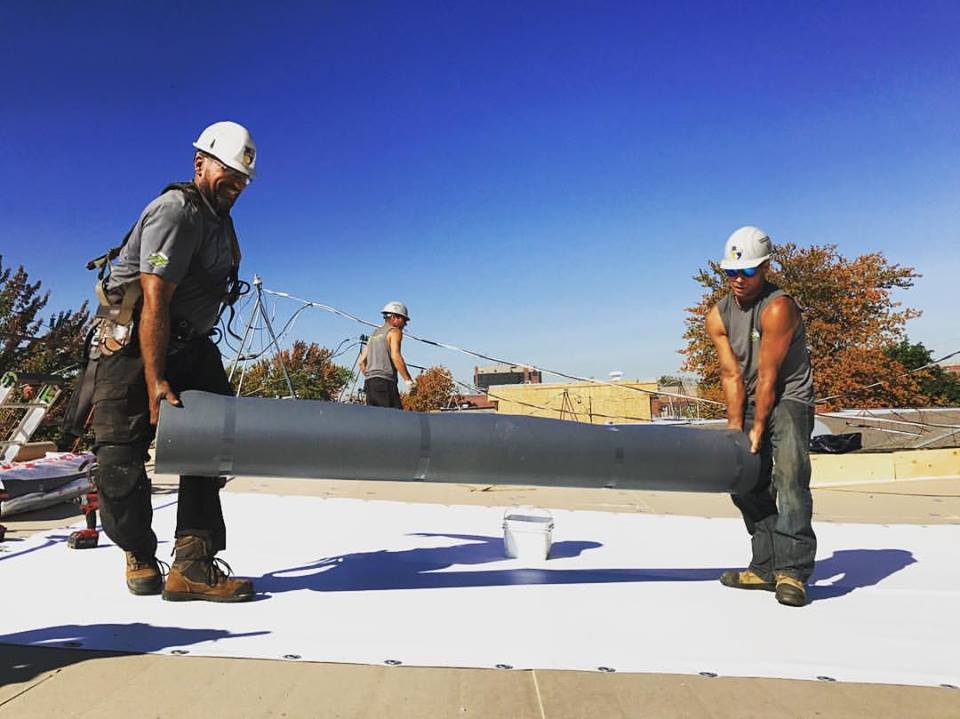 Membrane installation on a roof under construction.