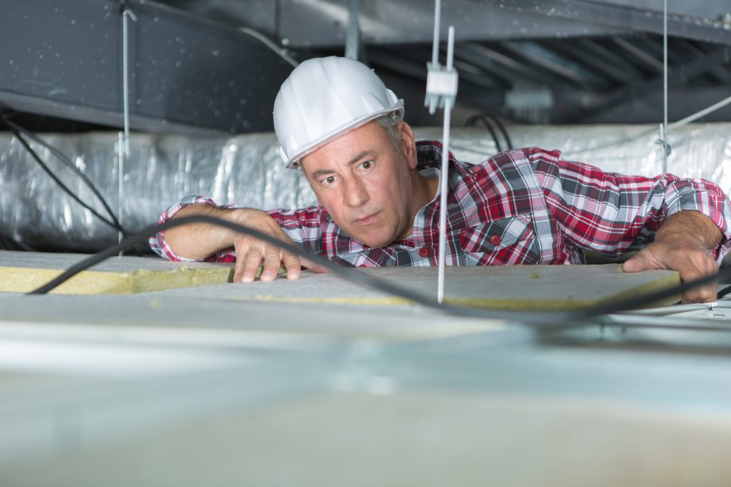 Worker repairing a flat roof