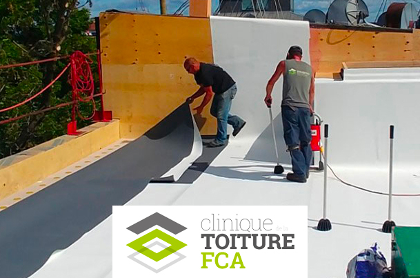 Roofers installing a membrane on a roof