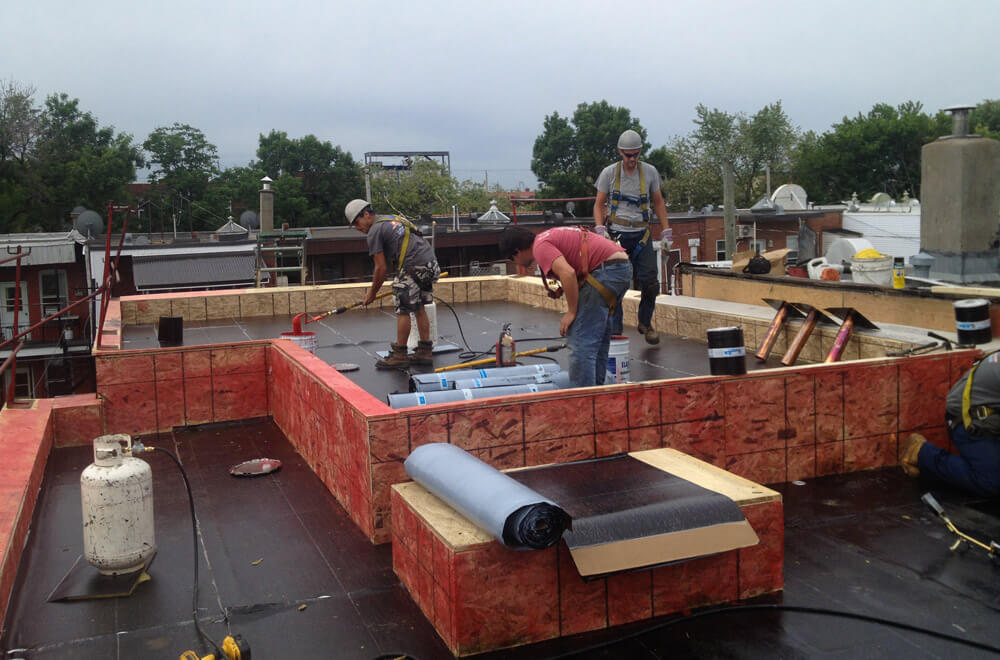 Elastomeric roof membrane installation.