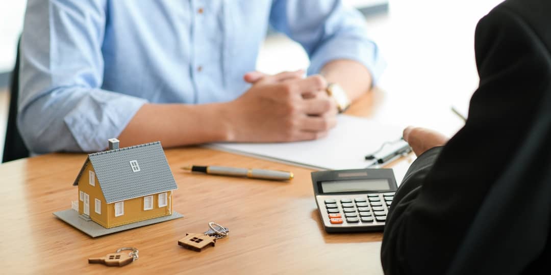 A man signs a financing contract with the bank for his roofing work