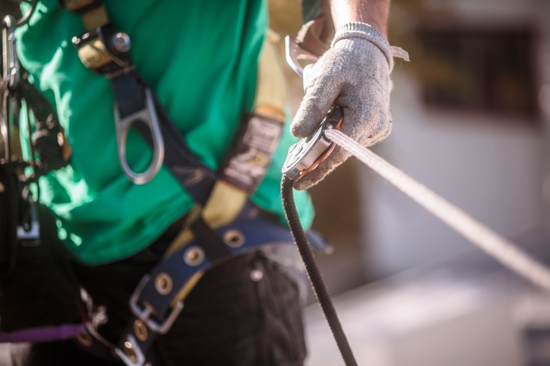 Close up of a safety harness attached to a worker.
