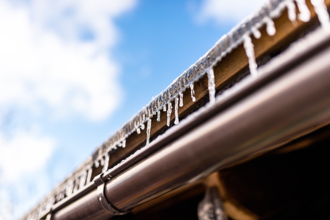 Icicles hanging from a roof.