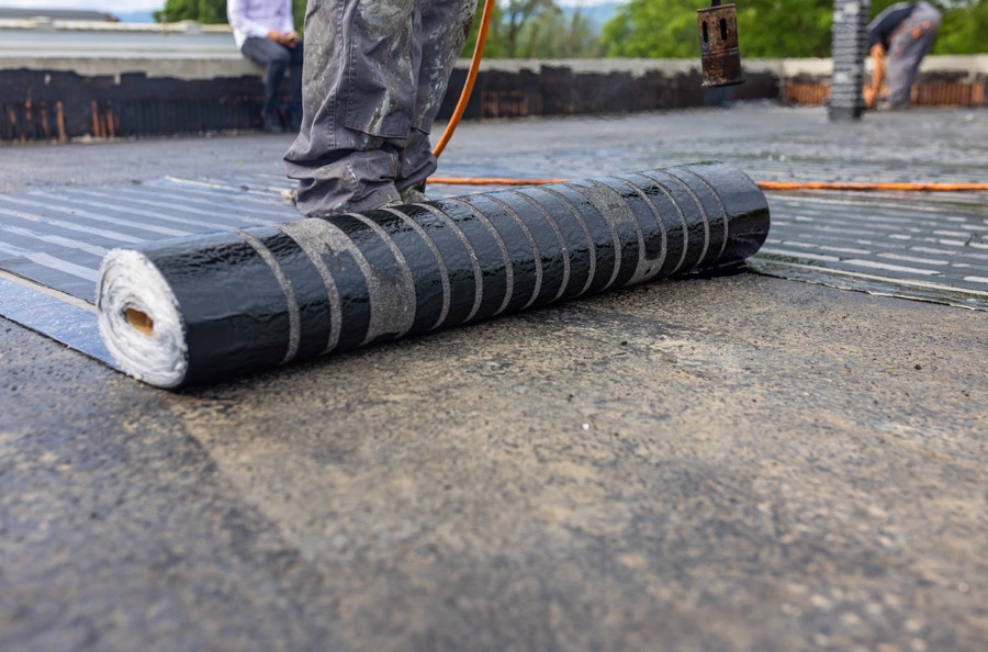Bituminous membrane waterproofing system details and installation on flat rooftop.
