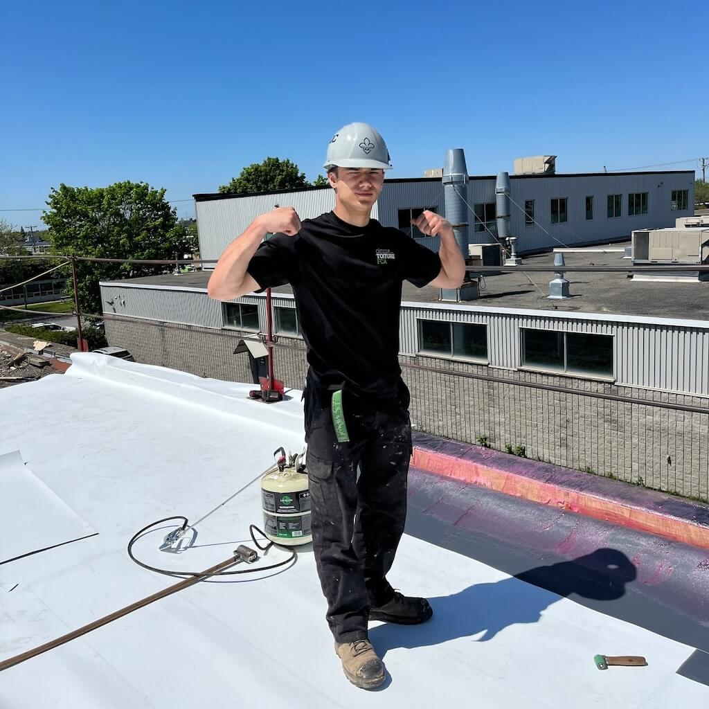 Worker maintaining a commercial or industrial roof.