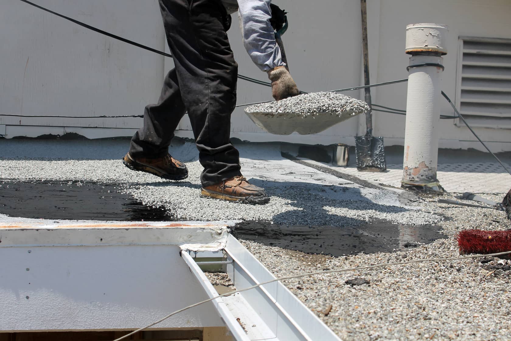 A traditional flat roof made of asphalt and gravel.