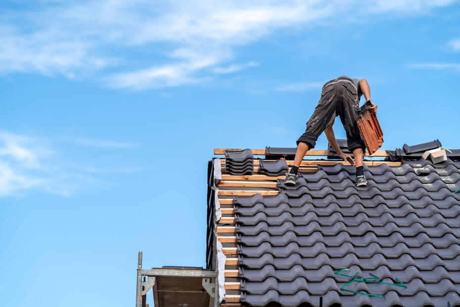 A worker on a traditional roof.