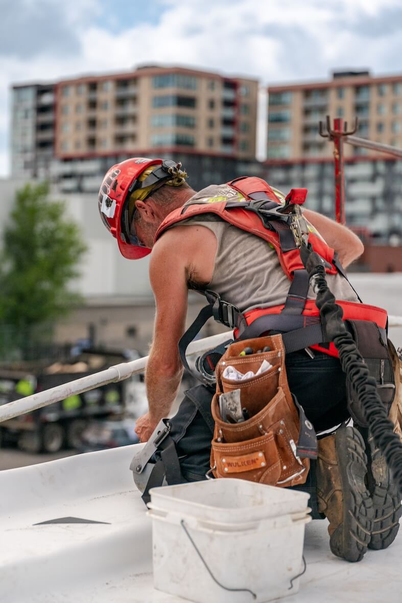 Worker on the insulation of an industrial roof.