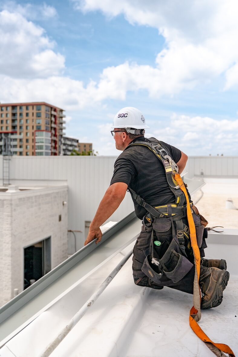 Worker on the insulation of an industrial roof.