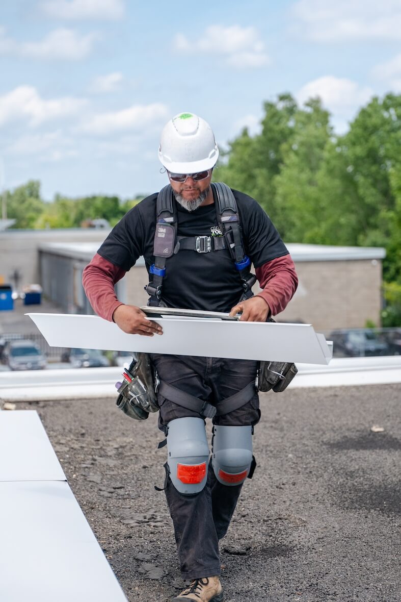 Worker on the insulation of an industrial roof.